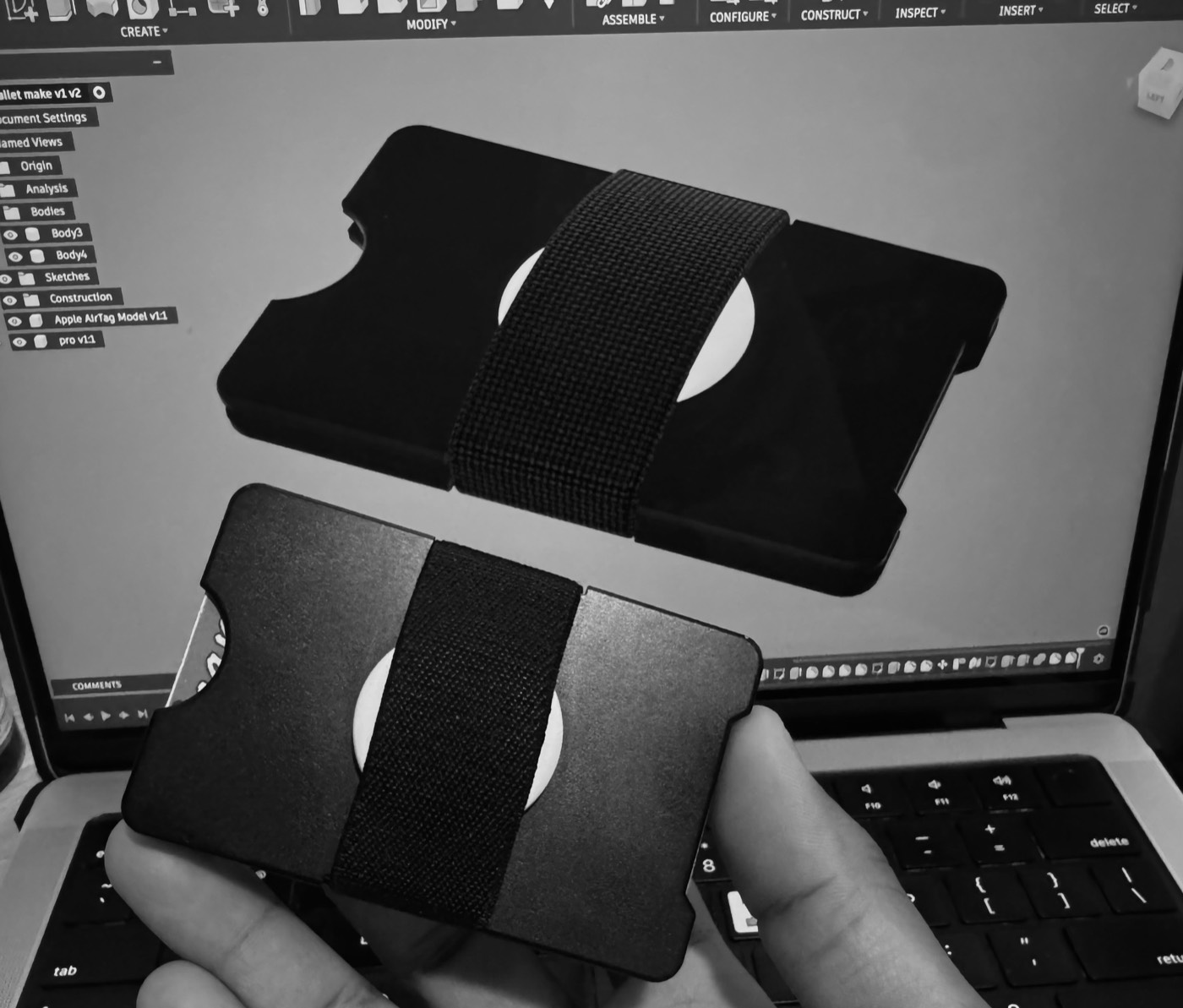 Finished Natan wallet held in front of its CAD model